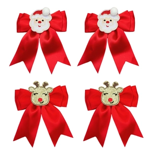 Christmas hair clips set with red satin bows featuring Santa Claus and golden reindeer motifs