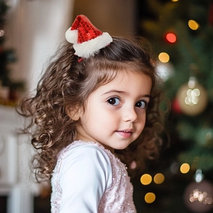 Close-up of a red sequin Christmas hat hair clip worn on a child's curly hair