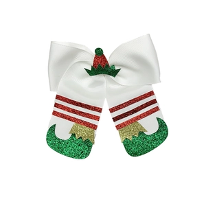 Detailed view of Christmas bow hair clip with festive glitter boots and Santa hat accents