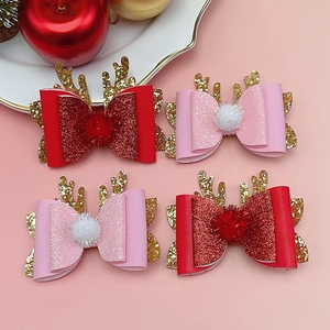 Set of 4 Christmas hair clips featuring reindeer antlers, glitter bows, and pom-poms