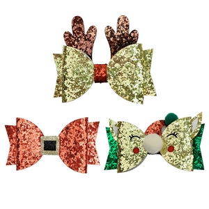 Three-piece Christmas glitter hair clip set featuring reindeer antlers and red bows