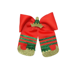 Detail of Christmas elf bow hair clip with red ribbon and green glitter hat and legs