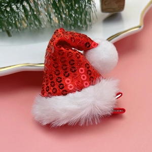 Sparkly red sequin Christmas hat hair clip with white plush trim and fuzzy pompom detail