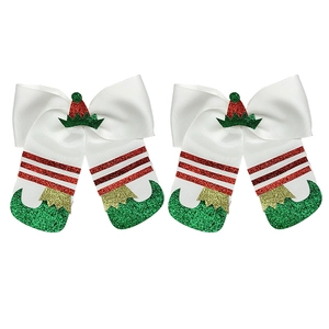 Detail of Christmas elf bow hair clips with red and green glitter boots and hats