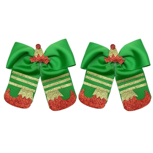 Detailed view of Christmas elf bow hair clips with green ribbons and red glitter boots