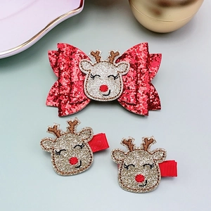 Close-up of a festive 3-piece Christmas hair clip set with red sequin bows and reindeer