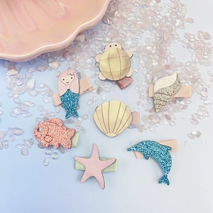 Detail of seven-piece ocean theme children hair clips set with glitter shells and sea animals