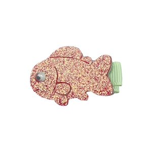 Detailed view of pink glitter fish hair clip with a 3D eye and green fabric-wrapped grip