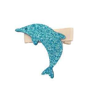 Detail of blue sequined dolphin hair clip with white ribbed ribbon wrapped base