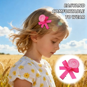 Close-up of a pink ribbon lollipop hair clip worn by a child with a scenic background