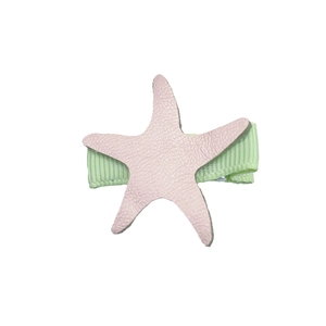Detailed view of pink starfish hair clip with textured PU leather and green ribbon base