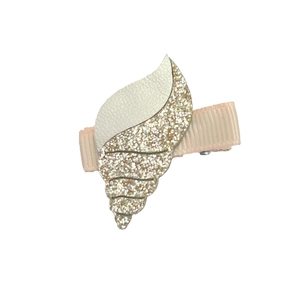 Close-up of shell hair clip with gold sequins and white faux leather for kids