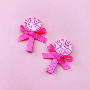 Detail of handmade lollipop hair clips with pink and white spiral ribbon bows for girls
