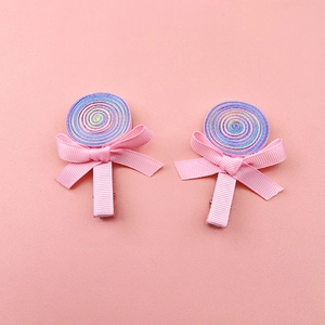 Detailed top view of rainbow ribbon lollipop hair clips with pink satin bows for girls