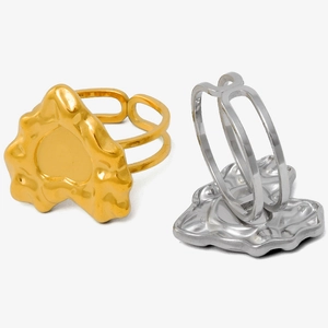 Detail of gold and silver irregular lava heart rings with liquid metal texture finish