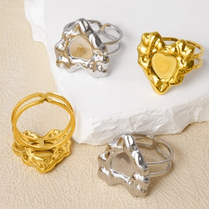 Detailed macro view of lava texture heart rings in gold and silver finish with open band