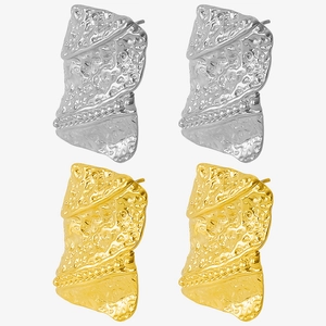 Macro detail of geometric hammered 304 stainless steel earrings with gold and silver finish