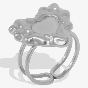 Detail view of silver molten lava heart ring with liquid metal texture and dual-band style