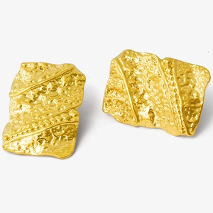 Detailed view of gold irregular geometric earrings with vintage lava texture and 18K finish