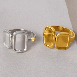 Detail view of gold and silver square double-tray rings in minimalist industrial design