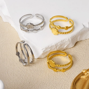 Detail of double-layer stainless steel sun rings with golden and silver relief finish