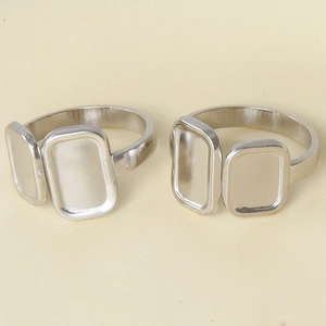 Macro shot of two silver stainless steel square base settings for DIY jewelry making