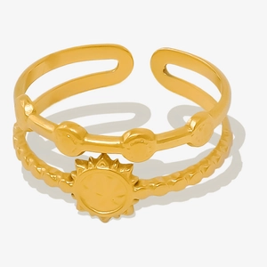 Detail of double-layer golden sun ring with hammered texture and open adjustable band