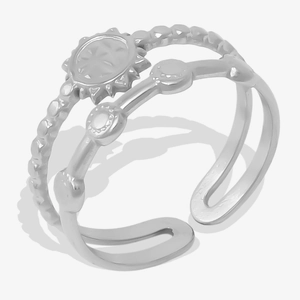 Detailed macro view of silver stainless steel double-layered ring with sunburst and studs