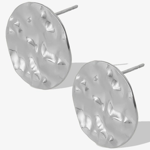 Macro detail of silver oval earrings featuring a modern hammered texture and metallic finish