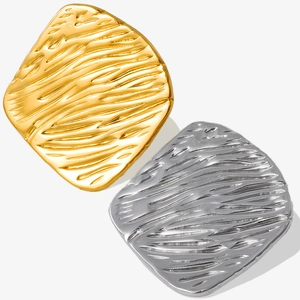 Macro shot of 18k gold and silver 304 stainless steel earrings with ripple texture