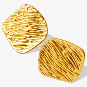 Macro detail of 18k gold plated 304 stainless steel earrings with textured water ripples