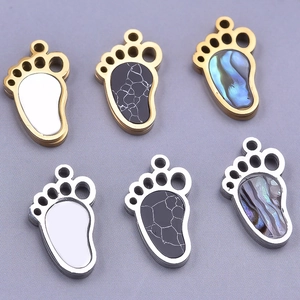 Detail showing variety of 304 stainless steel paw-shaped charms with colorful shell inlays