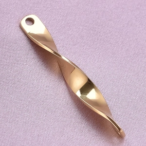 Macro shot of 304 stainless steel golden spiral twisted pendant with polished mirror finish
