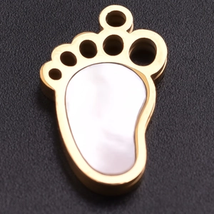 Close-up of golden stainless steel paw pendant with mother-of-pearl inlay for jewelry DIY