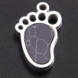 Macro shot of 304 stainless steel paw pendant with marble texture inlay detail