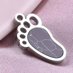 Detailed macro view of 304 stainless steel paw pendant with grey marble inlay and silver frame