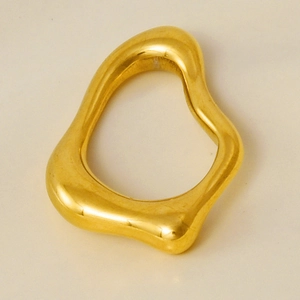 Macro detail of high polished irregular golden geometric pendant in 304 stainless steel
