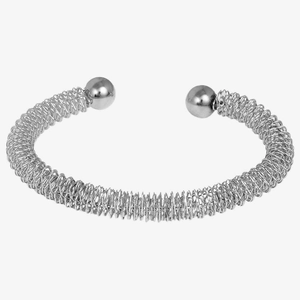 Detailed macro view of spiral wire coil texture and polished sphere ends of the silver cuff