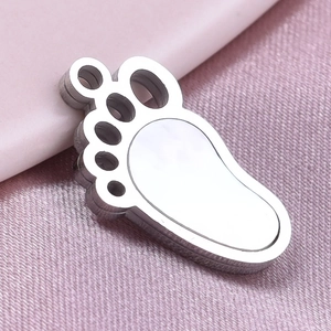 Macro detail of paw print pendant in 304 stainless steel with high-polished silver finish