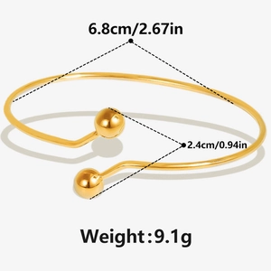 Detail view of adjustable 18k gold open bangle with 6.8cm diameter and metal beads