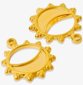Detailed macro of gold sun and moon pendants for DIY jewelry with polished hollow design