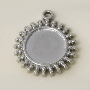 Macro detail of sunburst charm base in matte silver finish for jewelry making