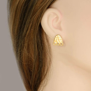 Golden stainless steel footprint triangle earrings with hammer pattern finish on model