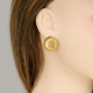 18k gold plated stainless steel sunburst hollow stud earrings worn by female model
