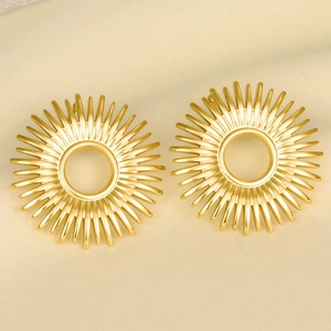 Detailed macro view of 18k gold plated sunburst stud earrings with geometric pattern