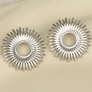 Detailed top-down view of hollow sunburst stainless steel stud earrings in silver finish