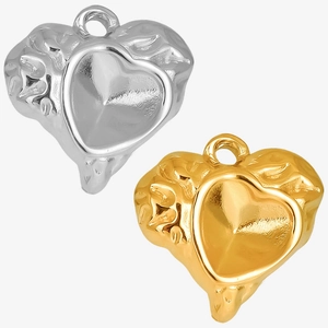 Detailed macro view of 18k gold and silver heart pendants with lava texture design