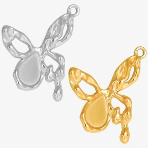 Detailed macro view of liquid metal butterfly pendants in silver and gold plating