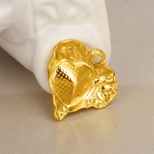 Macro shot of 18k gold 304 stainless steel heart pendant with textured hammered edges
