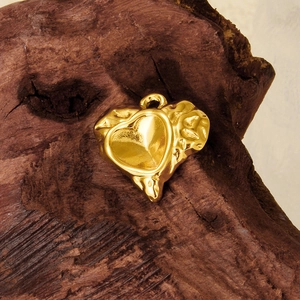 18k gold heart pendant with hammered texture and smooth center on rustic wood backdrop